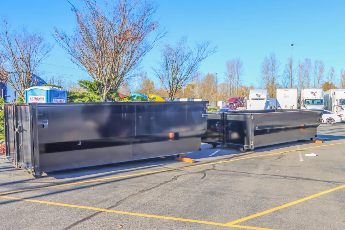 Professional dumpster rental service with roll-off container on residential driveway in Layhill